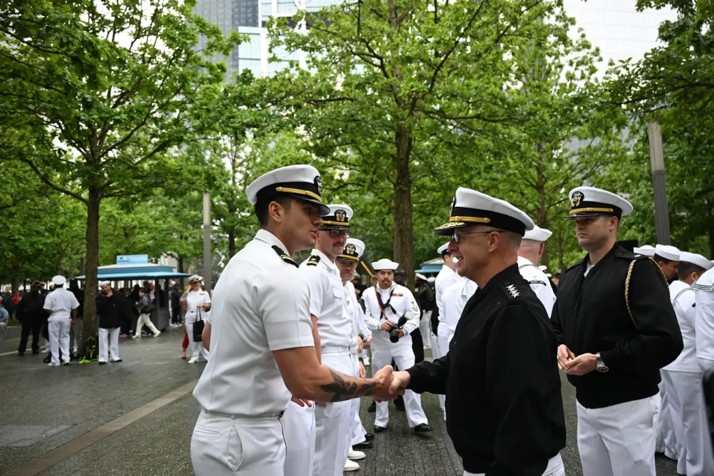 U.S. Navy Adm. Daryl Caudle, the commander of U.S. Fleet Forces Command, congratulates officers during a joint reenlistment and promotion ceremony